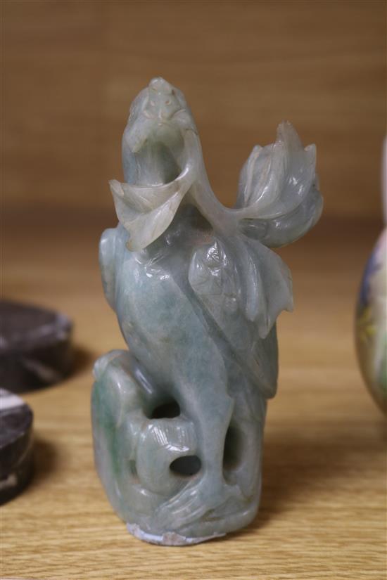 A Chinese celadon jade magnolia blossom, a jadeite figure of Guanyin, a pair of jadeite birds, a large soapstone figure of a lady and a